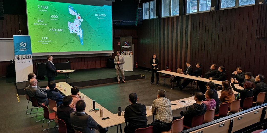 Modern classroom with students using tablets and interactive whiteboard, technology enhanced learning environment